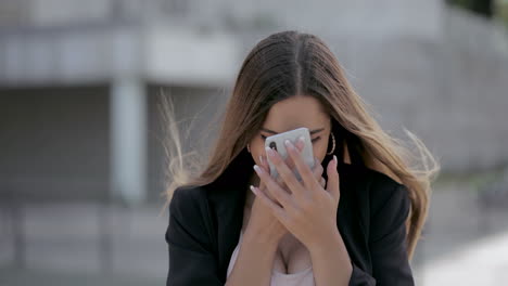 Excited-girl-using-mobile-phone-outdoor