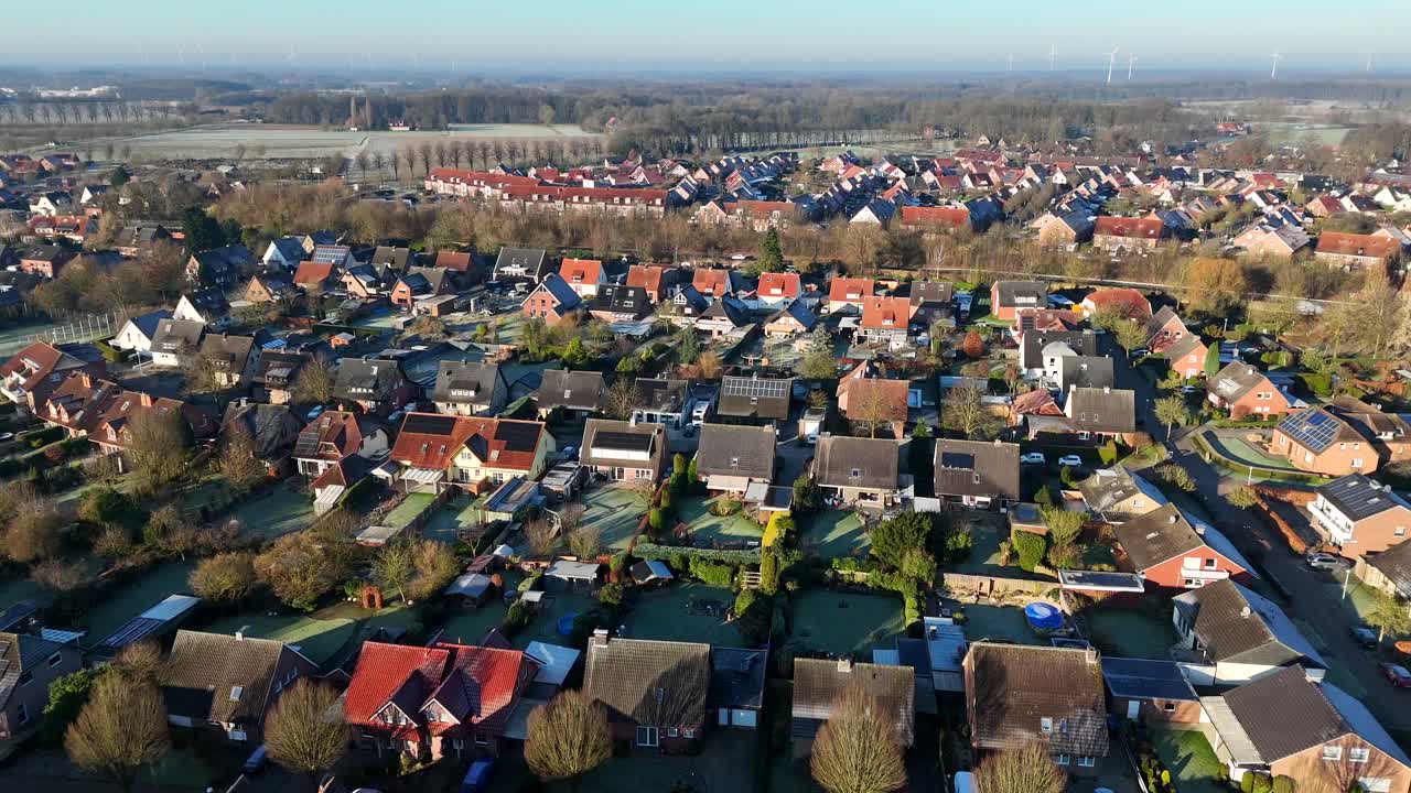 Housing area with single Family houses and solar panels on roof. Historic homes and houses in USA. Aerial forward wide shot. Sunny winter day in rural town.