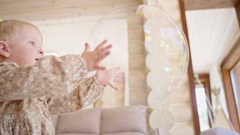 happy toddler playing with bubbles in a cozy home