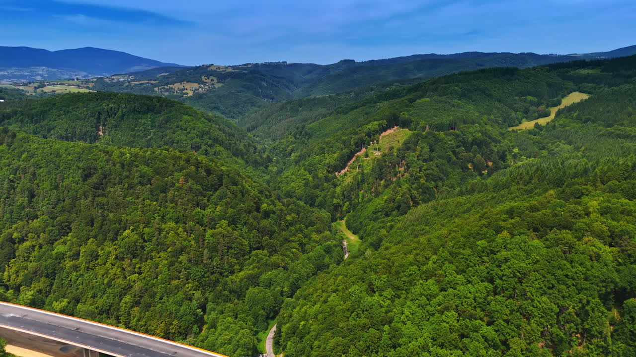 Vast green hills under clear blue skies. Lush green hills stretch across the landscape beneath a bright blue sky, showcasing nature's beauty in a serene setting