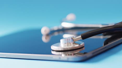 Video-of-stethoscope-and-tablet-on-blue-background-with-copy-space