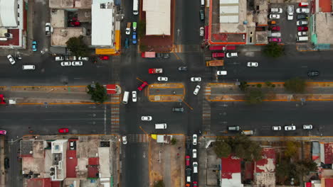 Drone-view-over-roundabout-with-moving-car-traffic-in-suburban-residential-district