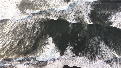 Top-down-view-of-black-sand-beach-at-El-paredon-Guatemala-during-sunrise