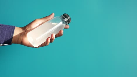 hand holding a plastic water bottle