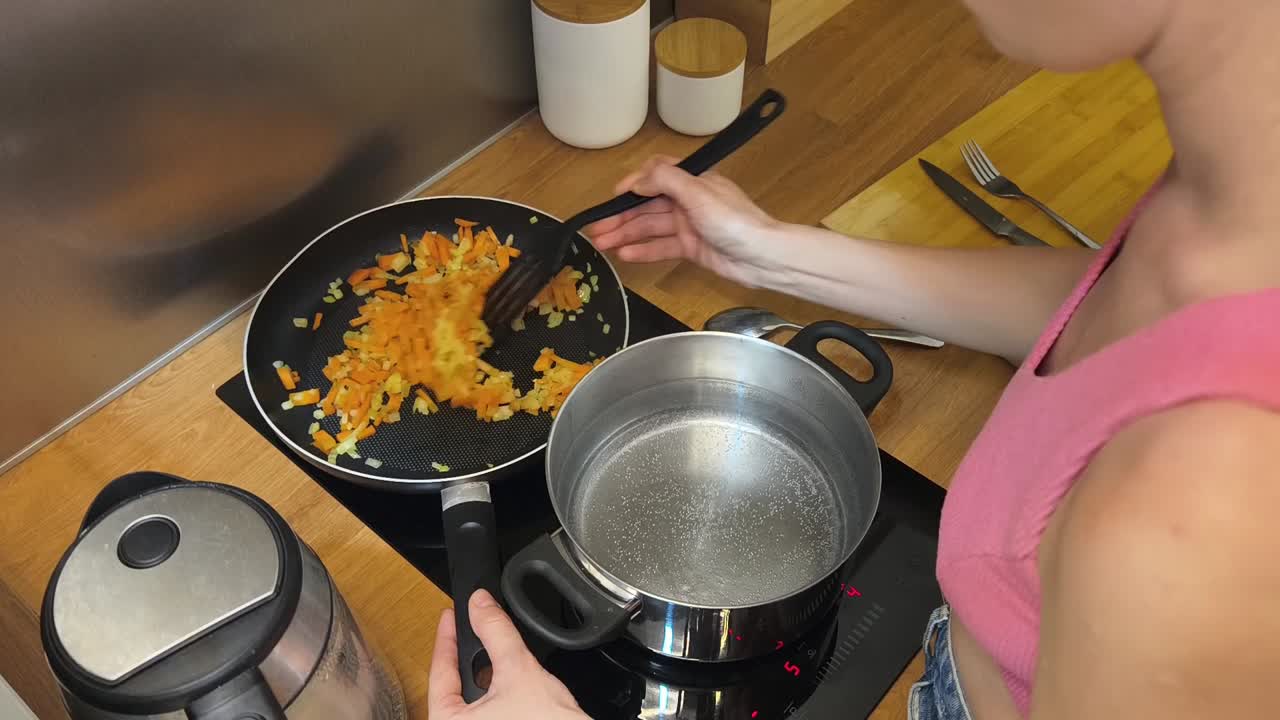 Woman cooking vegetables in the kitchen