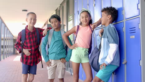 diverse students smile in a school hallway