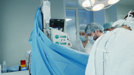 doctors team works with patient in surgery room. skilled surgeons take care of patient during coronary artery bypass surgery in cardiology clinic