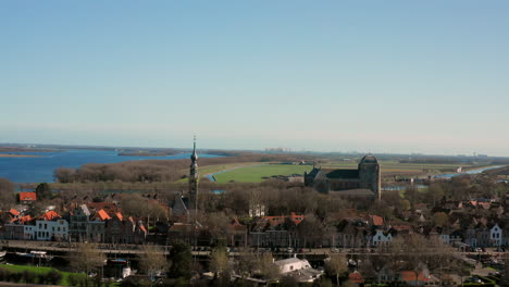 aerial: the historical town of veere with an old harbour and churches, on a spring day