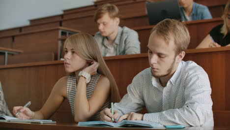 the college current audience in which students listen to the teacher and write a short film report in the notebook. transfer knowledge and educate students.