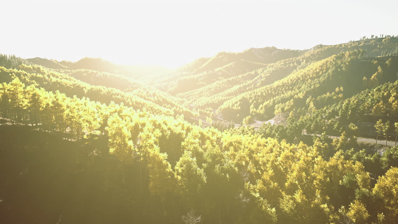 Sunrise over vibrant green hills creates a serene landscape