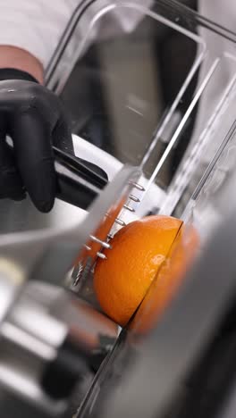 chef preparing orange in commercial kitchen