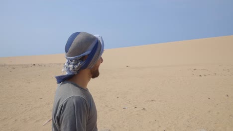 tourist in the desert bedouin scarf sun protection keffiyeh colombia la guajira sand dunes