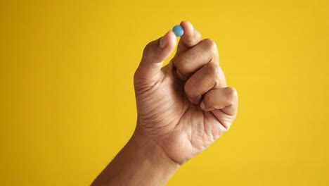 close up of man hand holding pills with copy space