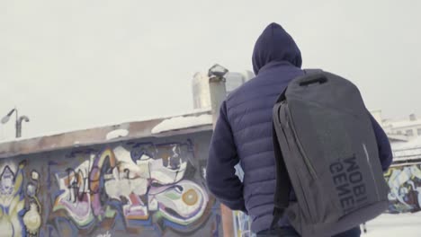 man walking in a snowy urban scene