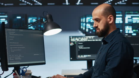 it engineer overseeing server room, running code, troubleshooting servers