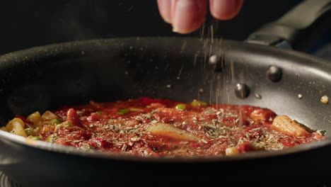 cooking pasta with vegetables and tomato sauce