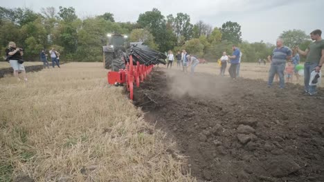 demonstration of agricultural machinery at an exhibition. tractors operate in the field, showcasing their capabilities and performance in action