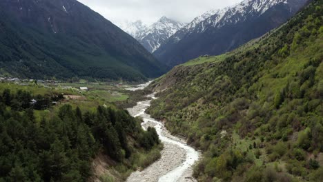 río que fluye a través de un valle de montaña sereno con colinas boscosas