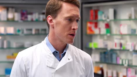 handsome pharmacist writing on clipboard