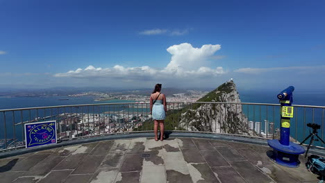 a woman at the gibraltar cable car top station overlook in spain