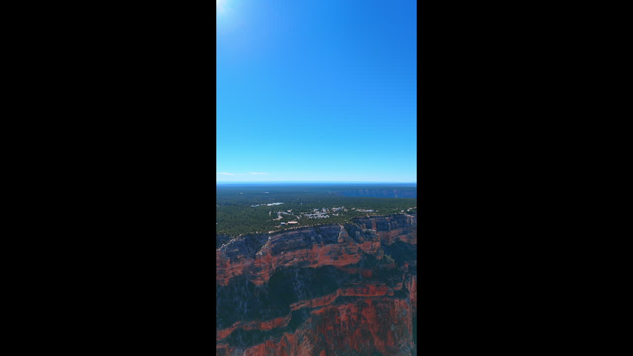 Rocks in the Grand Canyon National Park, Arizona, USA. Plain is covered with greenery on top of the canyons. Vertical video