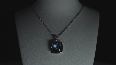 blue gemstone on a necklace on a bust