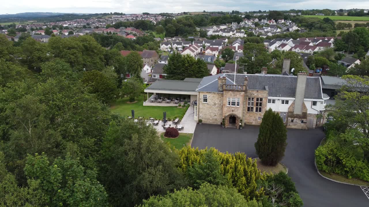 Aerial video on Dalmeny Park, a luxurious Scottish country mansion hotel with lush gardens and views of and nearby population