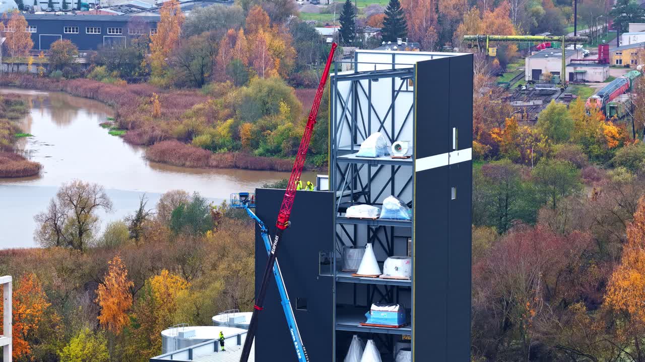 Aerial of modern apartment complex under construction with visible concrete structure and materials
