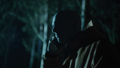 man on phone in the night forest