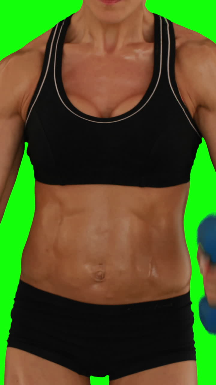 Super fit woman lifting dumbbells in black sports bra and shorts