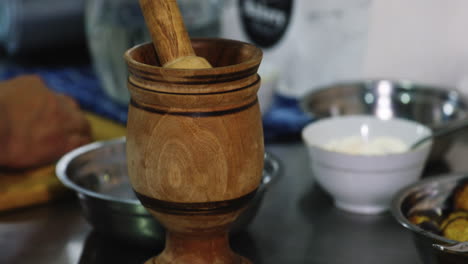 dinner ingredients and traditional wooden kitchen tool - mortar and pestle