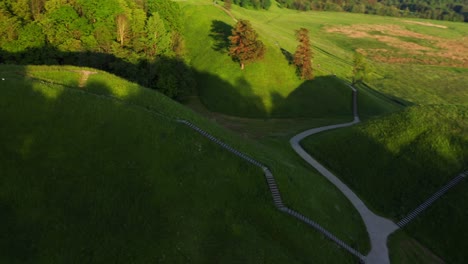 hills of kernave, tourist attraction and an archaeological site in lithuania - aerial drone shot