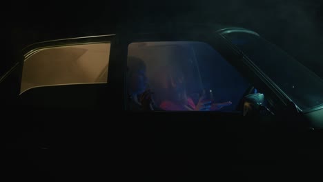 women in a car at night