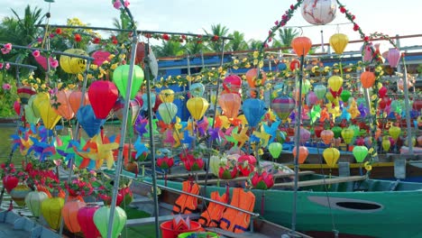 a stationary footage of small passenger boats with colorful lanterns and pinwheels that are parked on their docking area and are ready for rental by locals and tourists