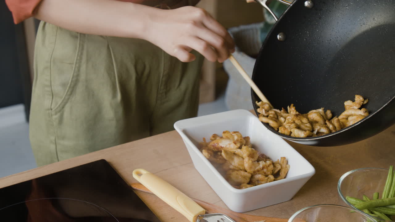 Woman Cooking Chicken Stir-fry in a Wok
