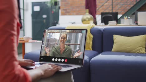 Animation-of-biracial-woman-having-video-call-on-laptop