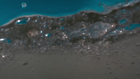 half underwater first person view of sea waves splashing on camera