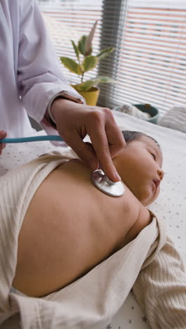 doctor examining baby with stethoscope