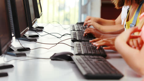 schoolgirls using computer in classroom