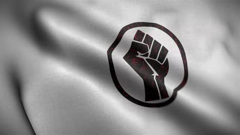 angled view of the white and black fist of power flag flapping in hd