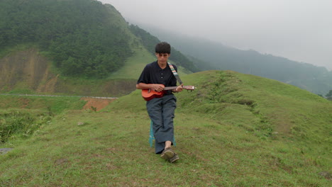 Musician-playing-the-Ukulele-and-singing-in-a-mist-covered-landscape