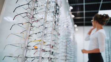 woman trying glasses. customer trying out frames at eyeglass store