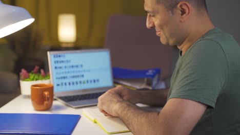 e-commerce man taking notes following new products online.