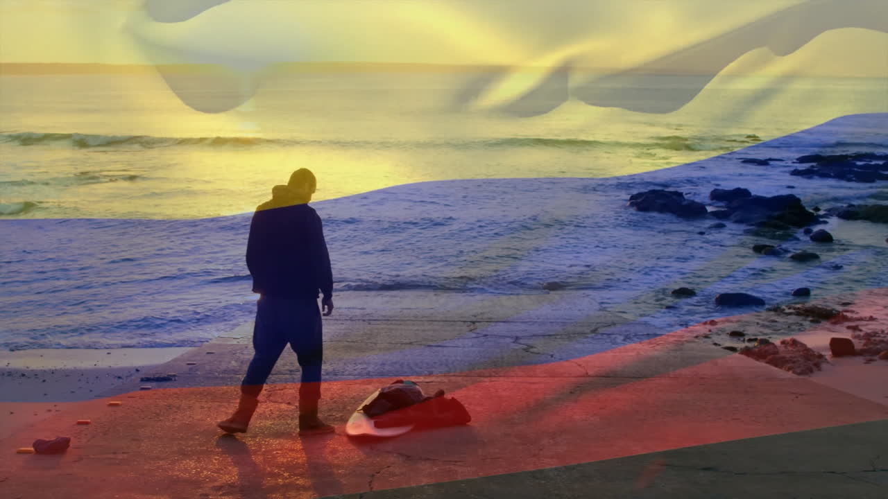 On beach, person with colorful animation overlay during sunset silhouette scene
