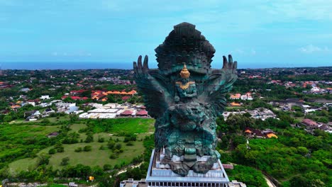 bali island landscape and iconic statue, aerial orbit view