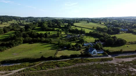 aerial view rising above traeth coch pentraeth welsh rural marshland scenic farming countryside at sunset