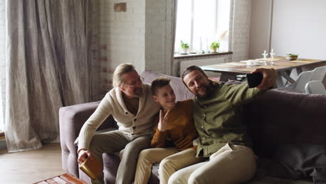 Grandfather-and-grandson-sitting-on-sofa