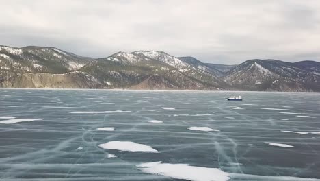 frozen lake with mountains in the background