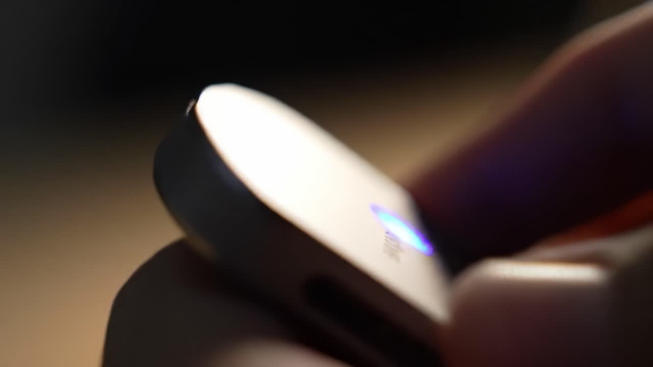 Close-Up Shots of a Sleek, Modern Device Highlighting Its Design, Features, and LED Indicators in a Soft Focus Environment