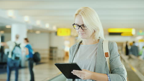 woman using tablet on travelator